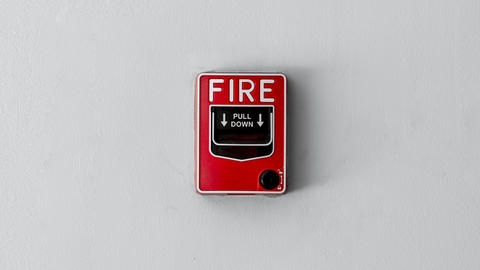 Fire pull alarm on a wall.