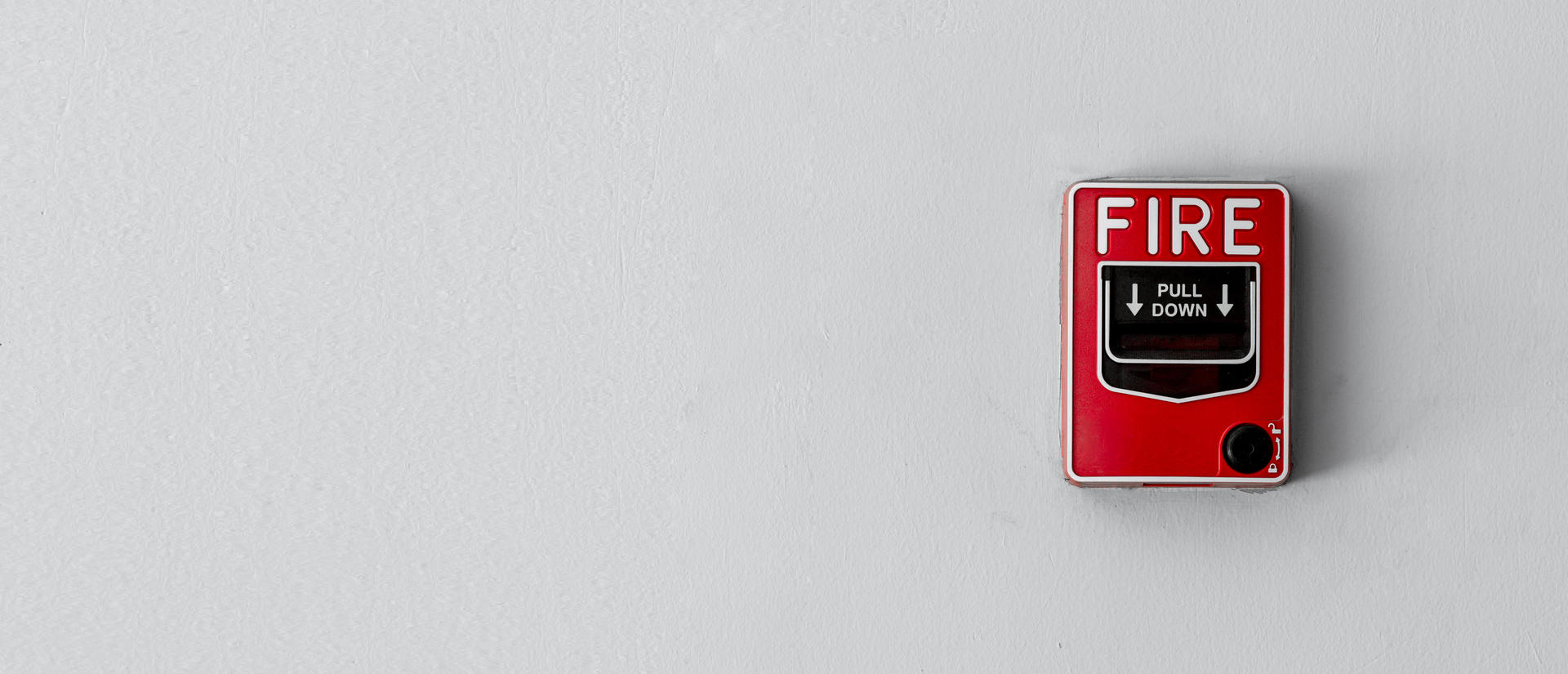 Fire pull alarm on a wall.